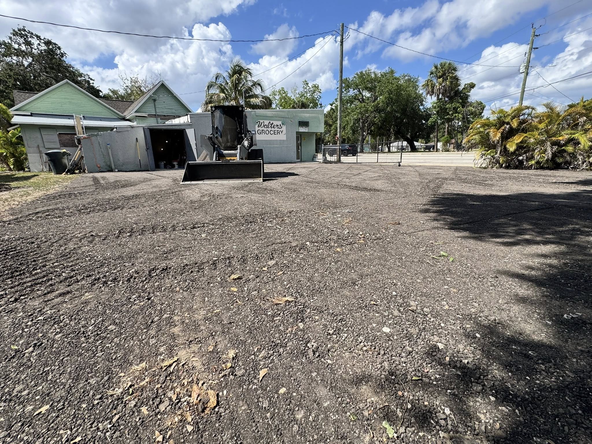 Track loader grading a commercial parking lot at Walters Grocery